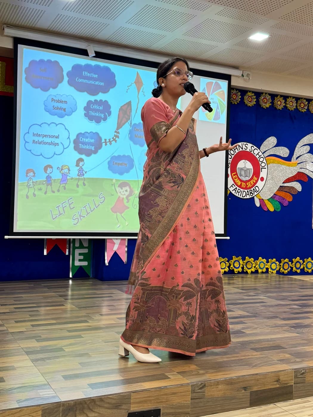Lamhi presenting on stage at the St. John's School CBSE Resource Person workshop