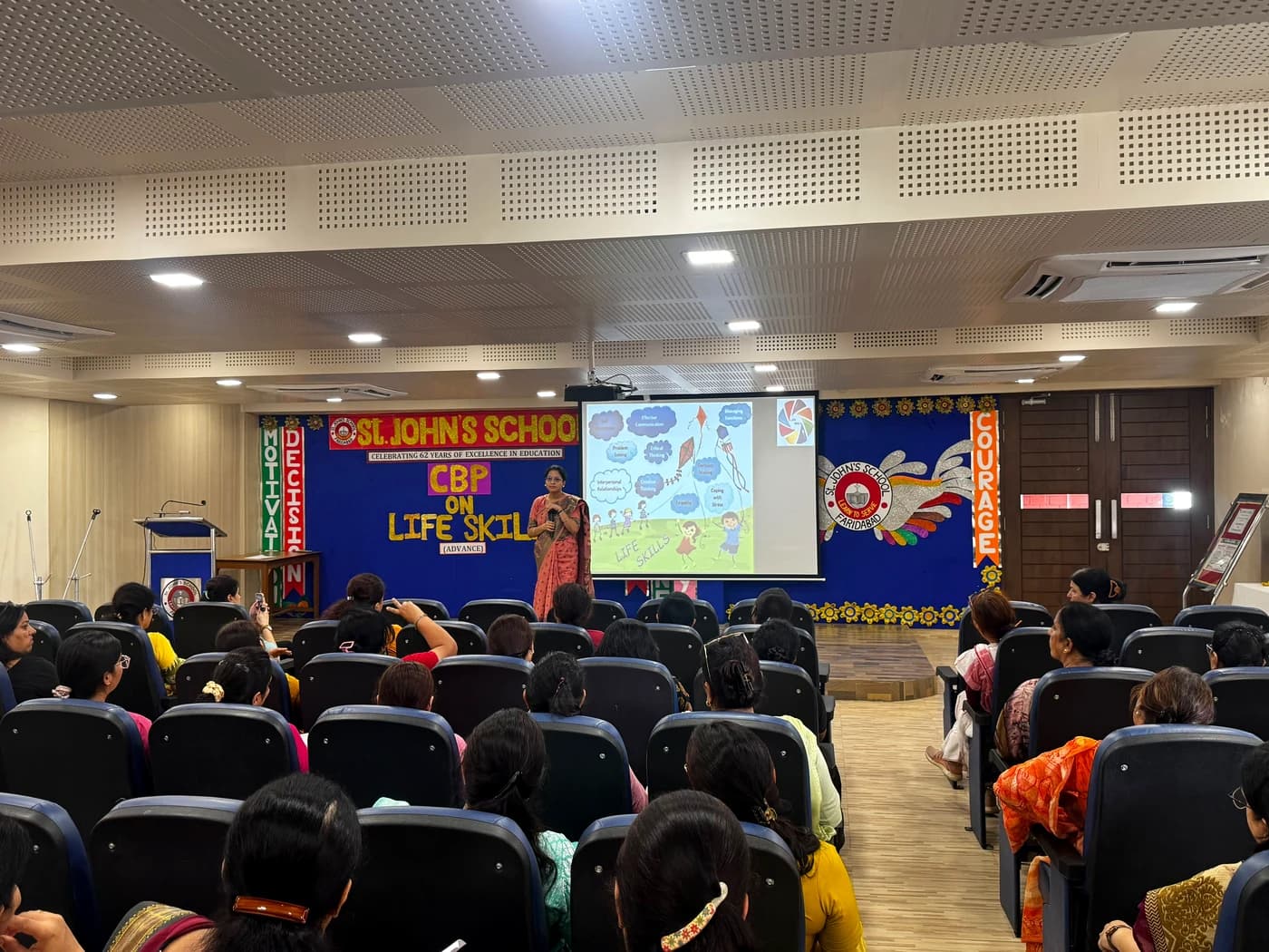 Teachers seated across the auditorium during the workshop